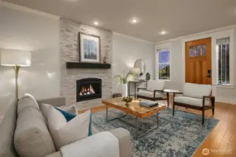 Welcoming living room with cozy gas fireplace greets you as you come through the front door