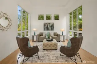 Formal living room has high ceilings and extra tall windows, bathing the room in light