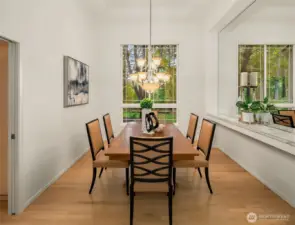 Formal dining with cantalevered ceilings and built in shelf