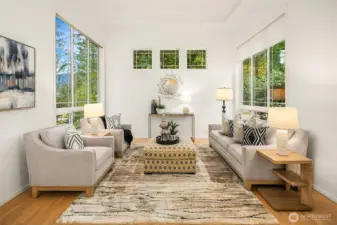 Step into a formal living room filled with sunshine, where high ceilings and tall windows create an open, airy ambiance perfect for relaxing or entertaining.