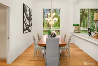 Gather in a formal dining space accented by stunning cantilevered ceilings and a stylish built-in shelf