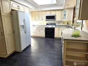 Pantry cabinet on this side of refrigerator