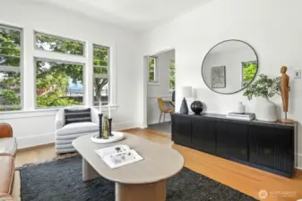 The expansive living room features high ceilings, timeless finishes, and abundant natural light.