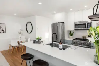 Open-concept kitchen, outfitted with premium appliances