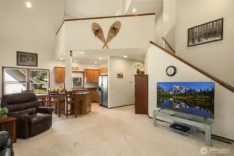 MOST FURNISHINGS STAY WITH HOME! This is the main living, dining and kitchen area. Stairs lead up to fabulous open loft (office space? guest quarters?) with extra sleeping room and 1/2 bath.