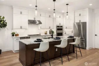 Gourmet kitchen with upgraded cabinetry, top of the line JennAir Appliances, beverage fridge and gas cooking Photos are for illustrative purposes only