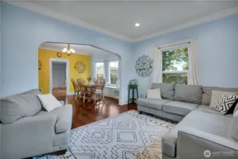 Large living room with gleaming hardwood flooring & great crown moldings!