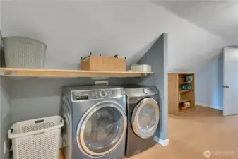Wonderful laundry area with shelving & storage!