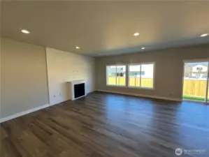 FOR ILLUSTRATION PURPOSES Family with gas fireplace, quartz mantel and LVP floors