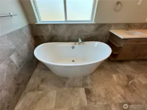 FOR ILLUSTRATION PURPOSES Spa like primary bath with free standing soaker tub, walk in tile shower with quartz floor, double vanity and water closet.