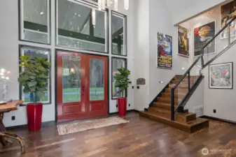 Large double doors greet you at the threshold.  As the doors swing open, you are welcomed into a spacious foyer that boasts high ceilings and an abundance of natural light.  The flooring, exotic Brazilian Momoqui, guides your steps into the heart of this stunning home.  This is your personal invitation to explore the beauty and sophistication of what lies beyond.