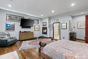 Primary suite on the main floor looking toward the large master ensuite with walk-in closest.