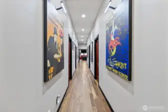 Four spacious bedrooms down this hallway, two on each side with bonus/game room at the end. And another stair case down to the kitchen outside of the game room.  Half bath in the game room as well.  Large utility room to the right just before you enter the game room.