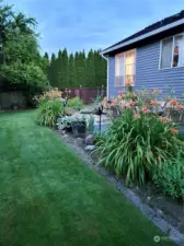 The Lush Grass in the Backyard is on the North side of the Home.