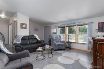 Light-filled main living area with front door off the large deck.