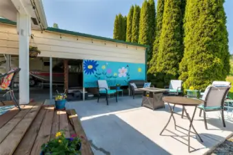The private back yard sitting area. The hot tub is behind the flowered screen.