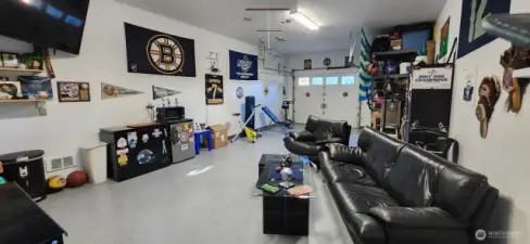 View of the frront of the HUGE garage. Currently used as a person cave and sports enthusiast hang out space!