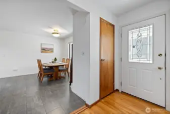 Entryway with hardwood floors and a coat closet