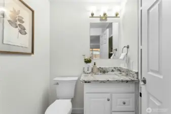 Refreshed powder room with new toilet, fan, vanity.
