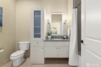 Full bathroom on the main level with a clean modern look and cozy soaking tub.