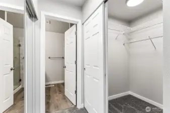 The primary bedroom has two closets, one to the left and a walk-in closet to the right.