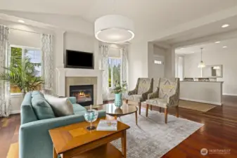 Open flow living room accompanied by a low-maintenance gas fireplace. Stunning hardwood floors stretch throughout the living areas on the main floor. The bedrooms, staircase, and upper-level hallway all have brand new carpeting.