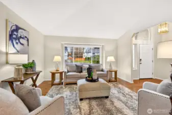 An inviting living area anchors the home with a high ceiling and a comfortable connection to the dining room through a wide cased opening. The front entry is set slightly apart, giving the room a more finished, intentional feel.