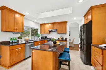 A bright skylight and recessed lighting keep the kitchen feeling light and welcoming throughout the day. Extensive counter space, a full appliance package, and a smart work triangle make daily cooking efficient, with the island offering extra storage and room to gather.