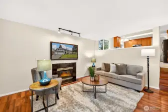 A spacious lower level gathering room provides a relaxed retreat separate from the main living areas. With wood style flooring, track lighting, and patio access, it’s a versatile space that adapts to the way you live.