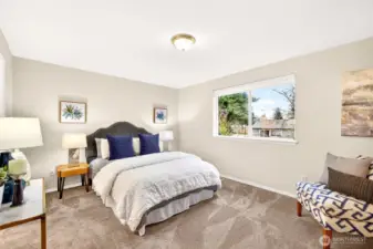 The primary bedroom offers a calm, spacious retreat with plush carpet and a wide window that brings in natural light. The generous layout provides flexibility for your preferred bedroom setup, plus room for a sitting area or workspace to support the way you live day to day.