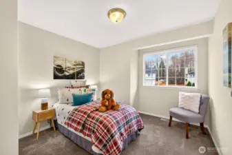 Another bedroom provides a bright, calming space with a wide window and plenty of wall space for your preferred layout. The neutral palette makes it easy to personalize.