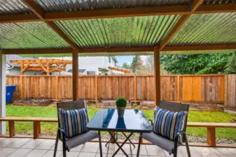 Step out to a covered patio that creates a true outdoor living zone, rain or shine. The fenced backyard includes raised beds and lawn space, offering a great balance of usability and low maintenance.