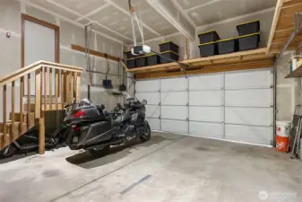 Vaulted ceilings in the garage allow for plenty of storage. Door leads to the hallway to the entry. Room for a small shop.