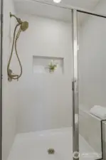 Tile shower and quartz vanity with clean, contemporary design