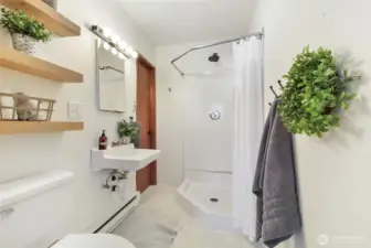 Primary 3/4 bathroom with access to utility room.