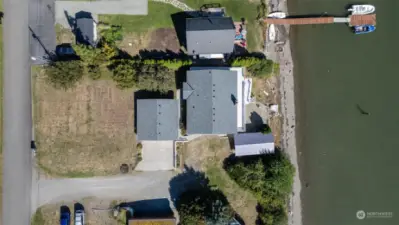 Aerial of the home, garage, boat house                    and beach.