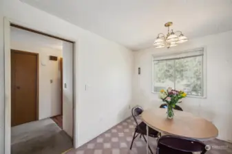 Entrance hall on the left and eating space in the kitchen.