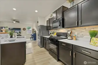 Kitchen has LVP Flooring installed in Oct. 2023, Quartz countertops, Brand new Range in May 2025, New Refrigerator in Dec. 2023, Undermount Deep Basin Stainless Steel Double Sink, Enormous Pantry