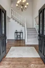 Grand entry way. Notice the rich dark refinished hardwood floors