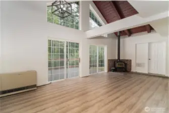 Living room with nice wood stove!  Large vaulted ceilings