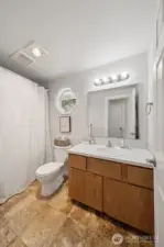 Full bathroom located upstairs between bedrooms.