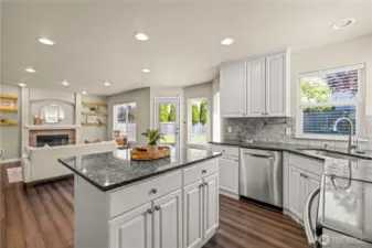 Large open kitchen with updated, stainless appliances, and island flowing to the family room and backyard patio.