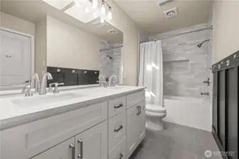 Newly updated bathroom with all new fixtures including quartz counters, new vanity, tile, & bathtub.