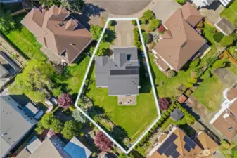 Large, fully fenced backyard with raised garden bed, patio, shed; ready for pets and yard toys.