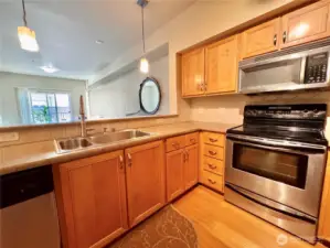 Kitchen looks out over living space and deck