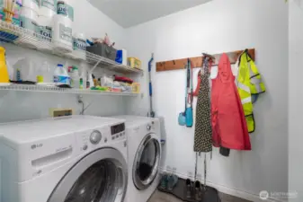 Great laundry room has a utility sink and good storage.