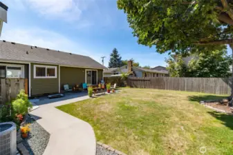 Fenced back yard with sunny southwest exposure, nice patio area, mature tree for shade.  AC unit shown at left.