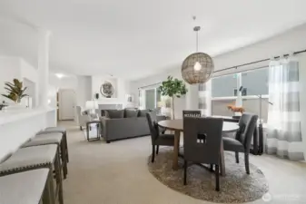 The open floor plan is bathed in natural light with large sliding glass doors.
