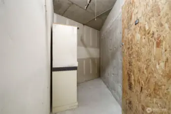A large storage space in the garage close to 2 of the parking spaces.