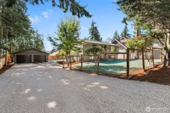 New landscaping with a large detached garage.